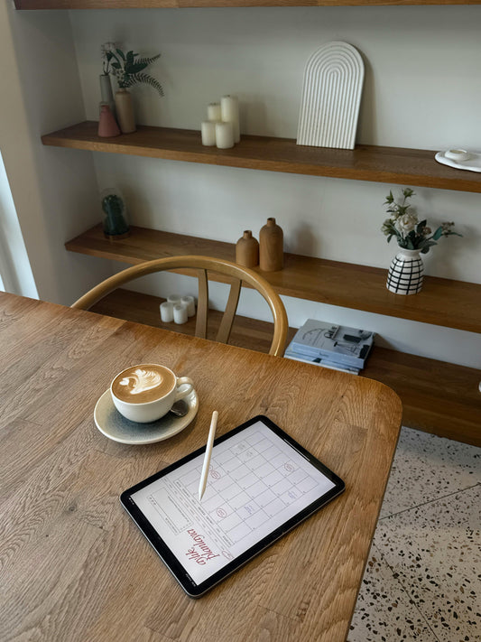 Tablet calendar and coffee on a wooden cafe table representing the timeline for California small claims court from filing