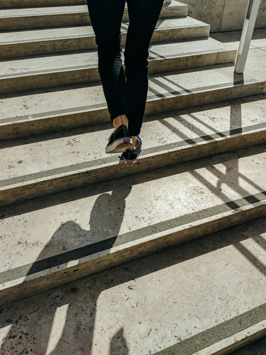 Person walking up wide stone courthouse steps, taking the next step to appeal a small claims judgment