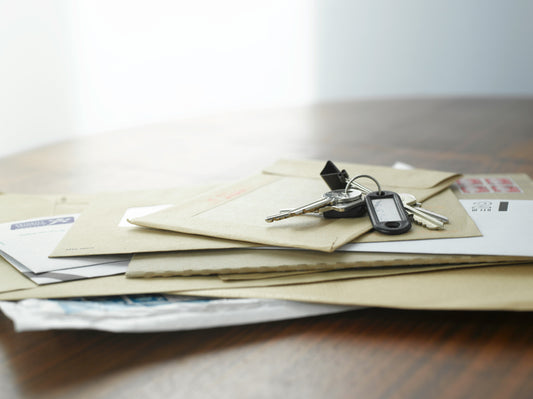 House keys resting on stacked paperwork and envelopes representing a California security deposit small claims lawsuit
