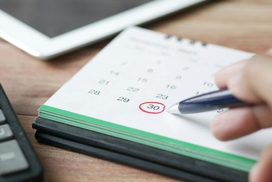 Hand circling the 30th on a paper calendar, illustrating missed deadlines that cause people to lose small claims cases
